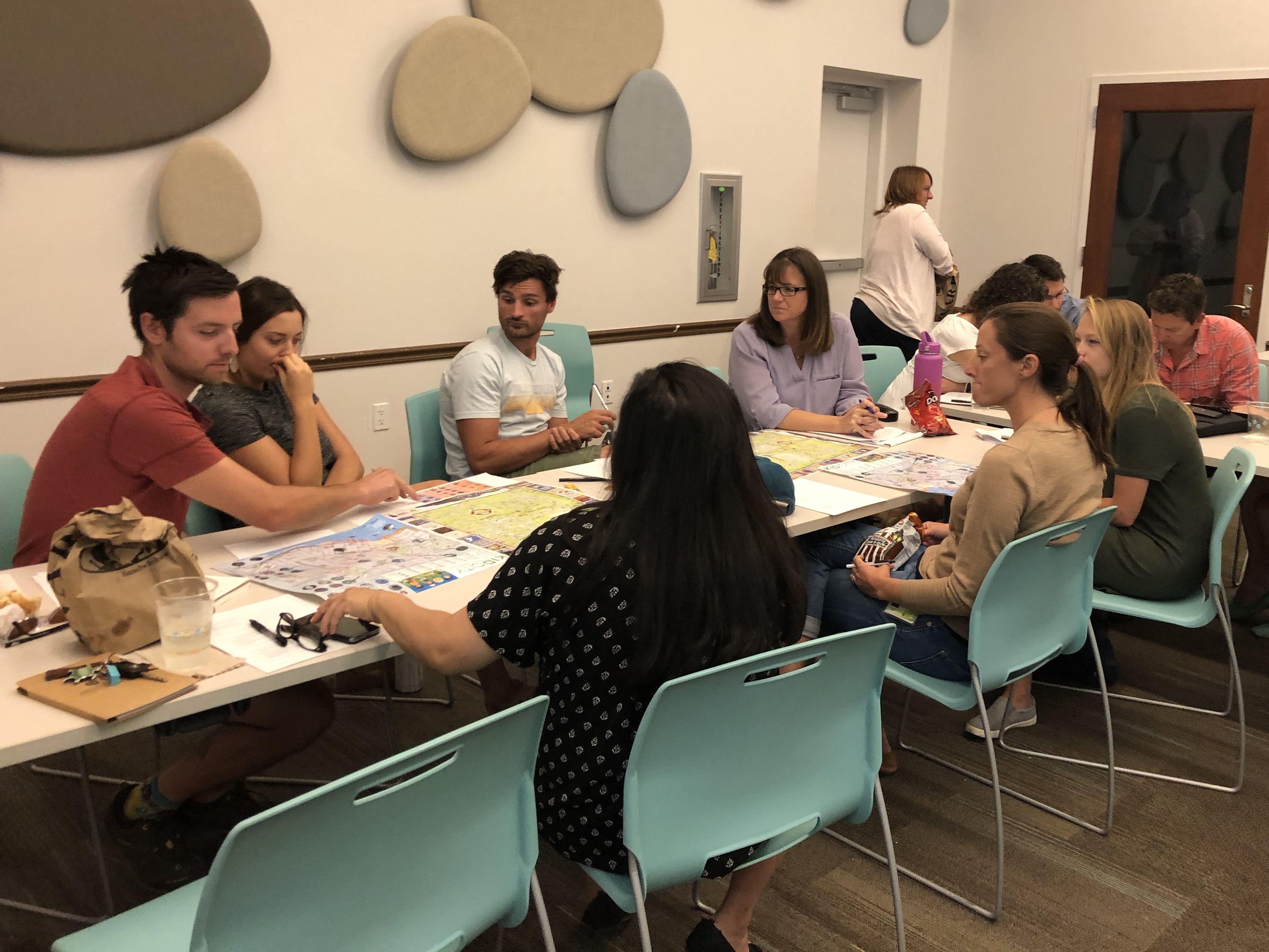 Adults brainstorming around table