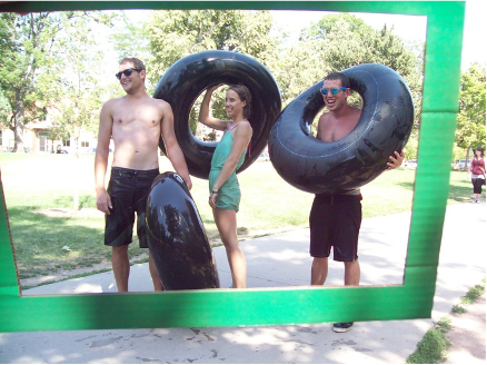 Young adults on a path with tubes for floating down the creek